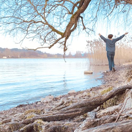 Corinna Fanni, Coach für Nervensystemregulation und emotionale Balance geniesst die Freiheit am Bodenseeufer.